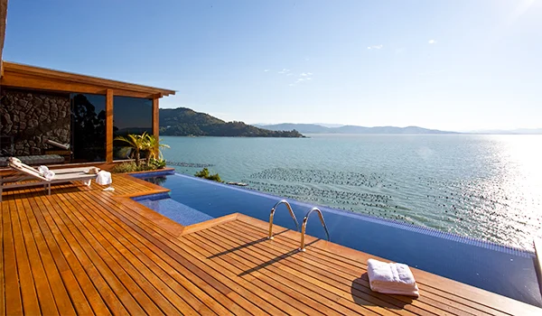 Foto da área externa de um chalé no Hotel Awasi, com piscina e em frente o mar e montanhas. Lugar perfeito para o o casamento em Ponta dos Ganchos.