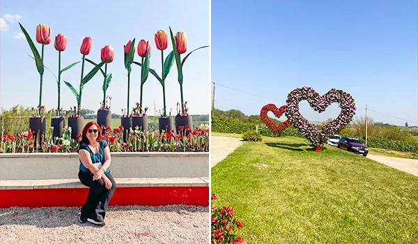 Foto de Deusa Rodrigues entre esculturas de flores e coração no Magic Park.