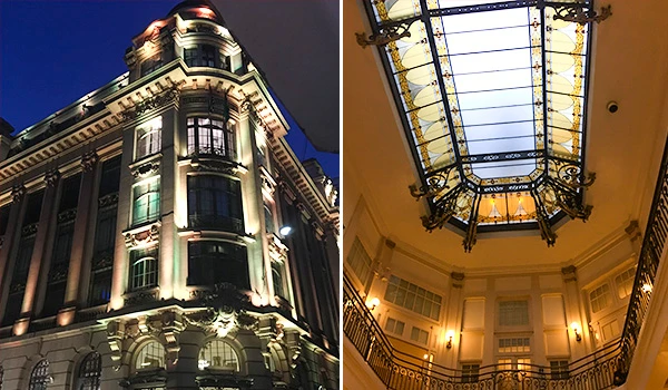 Imagem de um edifício histórico com iluminação arquitetônica e uma claraboia decorativa no interior, destacando sua arquitetura elegante e detalhada. Centro Cultural BB.