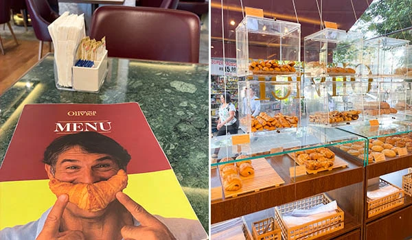 Imagem de um cardápio com uma pessoa segurando um croissant na boca na mesa de um restaurante ou padaria tradicional. Ao lado, uma vitrine com vários tipos de pães e croissants frescos em uma padaria moderna, com ambiente bem iluminado e clientes ao fundo.