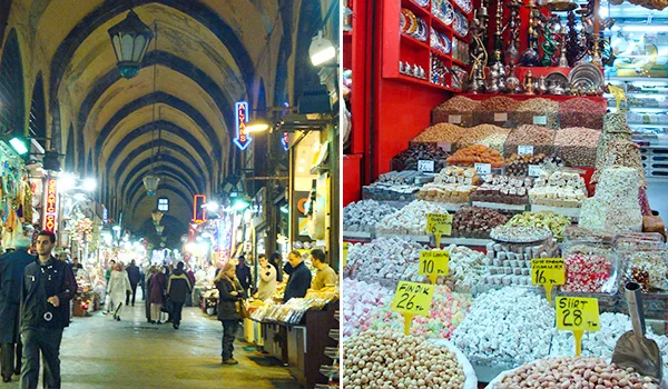 Mercado coberto do Grande Bazar, na Turquia, com corredores de arquitetura tradicional e arcos decorados. À direita, uma banca exibe uma grande variedade de doces típicos, como lokum, em diferentes cores e formatos, com placas indicando os preços.