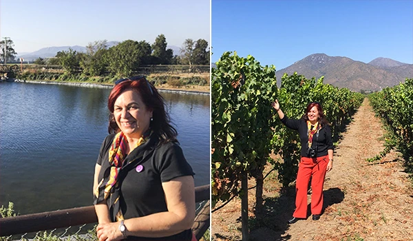 Deusa Rodrigues em passeio por vinhedo e perto de rio, aproveitando dia ensolarado rodeada por natureza, árvores e montanhas ao fundo. Vinícolas no Chile, qual visitar?