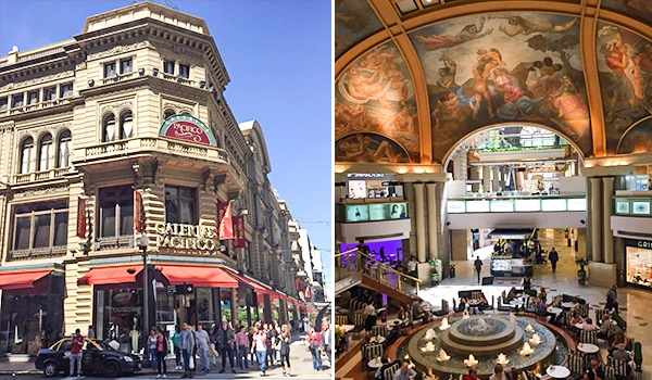 Imagem de um centro comercial de luxo com arquitetura clássica e teto decorado com pinturas artísticas, mostrando movimento e elegância.