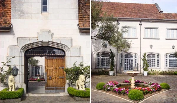 Imagem de duas casas impressionantes com arquitetura elegante, jardim bem cuidado com fontes e vasos de flores, destaque para detalhes arquitetônicos clássicos. Lua de Mel em Campos do Jordão.