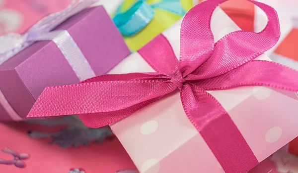 Imagem de presentes decorados com fitas coloridas, ideal para temas de celebrações e festividades. Presentes com laços e design encantador.