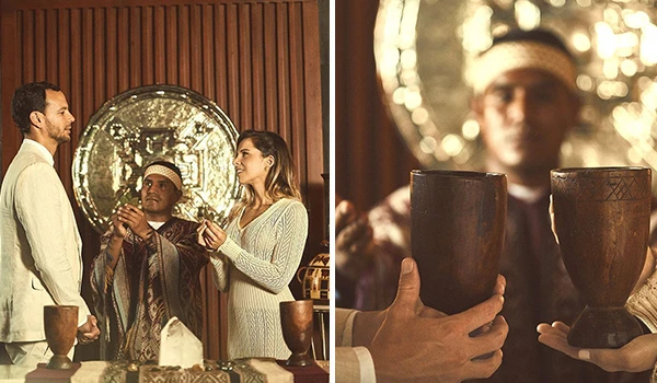 Imagem de duas pessoas em uma celebração elegante, com decoração sofisticada e iluminação acolhedora, capturando um momento de confraternização e alegria. Casamento e renovação de votos no exterior.
