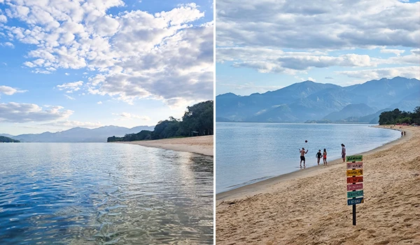 Imagem de uma encantadora praia com água cristalina e areia dourada, cercada por montanhas ao fundo, ideal para lazer e relaxamento em contato com a natureza.