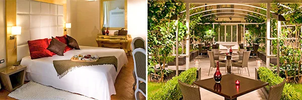 Quarto de hotel elegante com cama de casal, cabeceira acolchoada, almofadas decorativas e móveis clássicos. Ao lado, área externa arborizada com mesas e cadeiras para refeições.