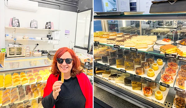 Foto de Deusa Rodrigues provando um doce e ao fundo vitrine com diversos doces da By Kim Confeitaria.