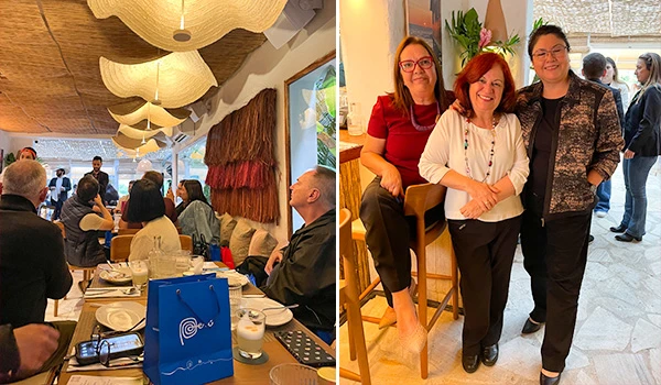 Reunião com pessoas em um restaurante sofisticado, ambiente moderno e decoração acolhedora, ideal para eventos corporativos ou confraternizações.