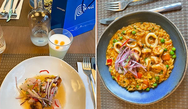 Imagem de pratos de culinária, incluindo um risoto de frutos do mar com ervilhas e outros ingredientes, e uma preparação de peixe com vegetais. Ambiente de restaurante, talheres e copo de bebida ao fundo.