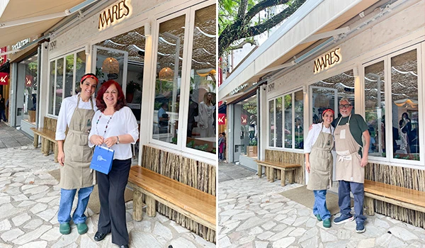 Imagem de duas pessoas, um casal, posando na frente de um restaurante chamado 'Mares', com ambiente ao ar livre, roupas de trabalho e sorriso no rosto.