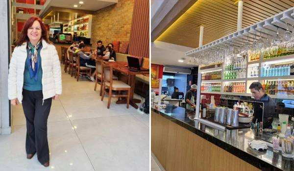 Imagem de um ambiente de bar com baristas preparando drinks e área de clientes, com decoração moderna e iluminação aconchegante.