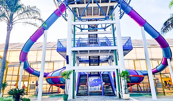 Parque aquático com toboágua colorido e estrutura de brinquedos, ideal para diversão em família e lazer aquático. Dicas para passar um dia no Wet´n Wild.