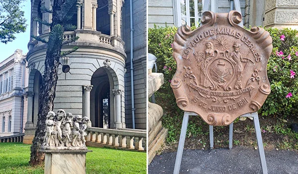 Fotografia em duas partes dos jardins do Palácio da Liberdade. À esquerda, vê-se a fachada ornamentada do palácio, com colunas, arcos, uma sacada e uma escultura de figuras humanas sobre um pedestal, cercadas por gramado e árvores. À direita, há uma placa ou brasão de pedra com inscrições e símbolos em relevo, apoiada sobre um suporte metálico diante de vegetação florida. Visita ao Palácio da Liberdade.