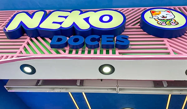 Foto da fachada do Neko Doces na Liberdade, na cores azul, amarelo, rosa e verde com logo de bichinho.