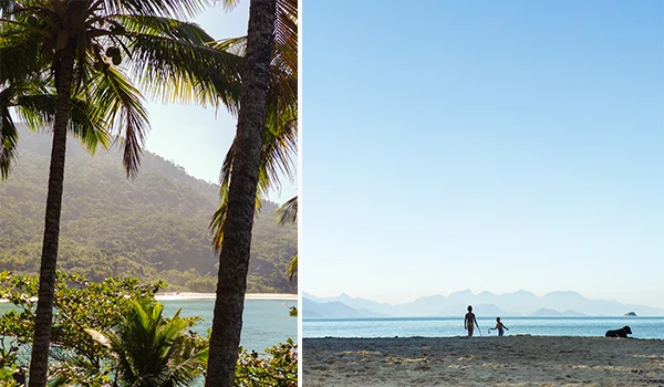 Paisagem de praia com árvores e vista para o mar com montanhas ao fundo, durante o dia, com céu limpo e tranquilo, ideal para turismo e lazer Rota Verde Azul.