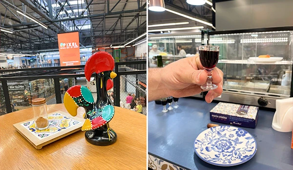 Imagem de uma mesa com decoração divertida e uma taça de vinho tinto, com ambientes internos ventilados e detalhes em porcelana azul e branco. Mercado de Santo Amaro restaurantes.