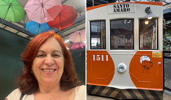 Deusa Rodrigues e uma montagem de objetos coloridos ao fundo e um bonde antigo um dos restaurantes do Mercado de Santo Amaro.