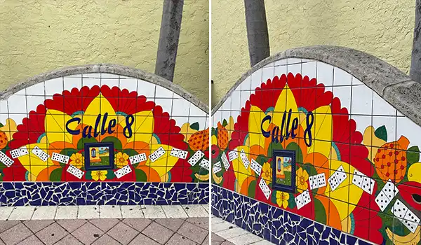 Mosaico colorido na parede com o nome Calle 8, representando a cultura e arte local. O mural é elaborado com azulejos e elementos vibrantes.