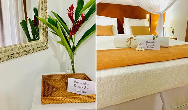 Decoração de quarto aconchegante com flores e mensagens de boas-vindas, transmitindo hospitalidade e acolhimento.