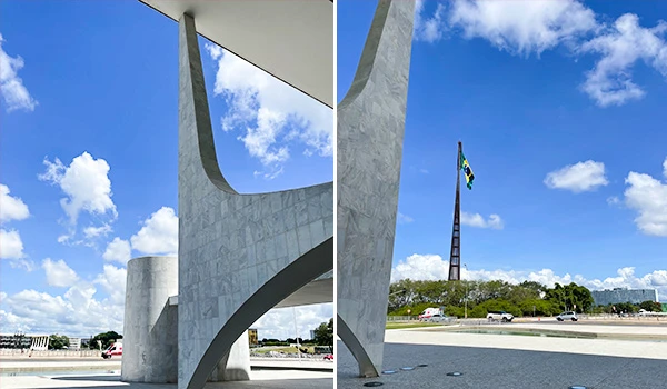 Vista da arquitetura moderna de Brasília, destacando a bandeira do Brasil e as estruturas em mármore sob um céu azul.