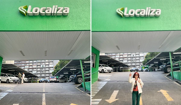 Imagem de uma pessoa usando máscara de proteção e óculos escuros, no estacionamento de um shopping com sinalização para entrada. Foco na fachada do local 'Localiza'.