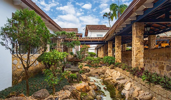 Banheira de hidromassagem na varanda com vista para a natureza, espaço de relaxamento e bem-estar em ambiente confortável e elegante.