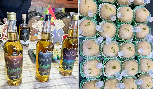 Vários copos com bebidas e uma mesa decorada, ao lado uma caixa com brigadeiros com um conta gotas de cachaça Três Pedras.