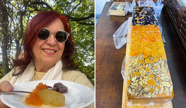 Deusa Rodrigues com óculos de sol segurando um prato com alguns doces ao lado foto de uma barra de doces diversos. Rotas Gastronômicas do interior de SP.