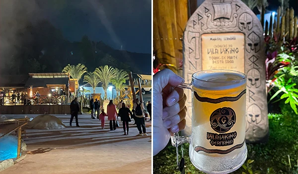 Imagem de turistas no vilarejo vikings durante a noite, com iluminação agradável, e uma mão segurando um copo chopp uma escultura rústica que celebra a cultura nórdica. Vila Viking e o “Quarto do Rei”.