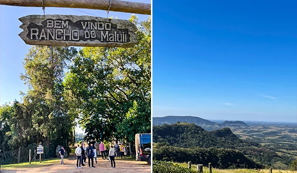 Imagem de boas-vindas na entrada do Rancho do Maluli, com turistas e vegetação, e uma linda paisagem de montanhas e céu claro. Rotas Gastronômicas do interior de SP.