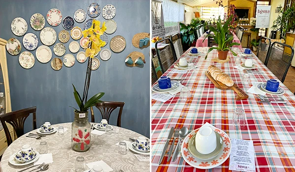 Imagem de duas mesas postas para café da manhã, com decoração de pratos decorativos na parede e outra com toalha xadrez colorida e louças para refeição, ambos ambientes elegantes e aconchegantes.
