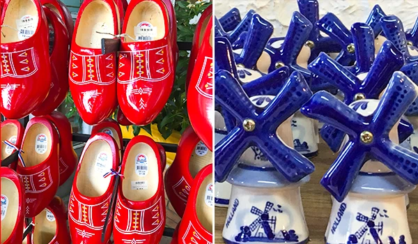 Imagem de artesanato de Delft com sapatos de barro vermelhos e mini moinho de vento azul tradicional em Delft, Holanda, destaque para a cultura local.