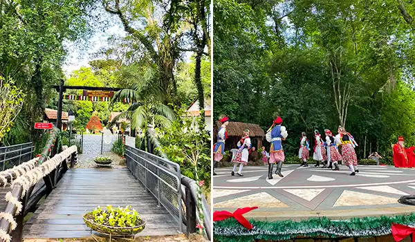 Imagem de um parque com um caminho de madeira, árvores verdes e área de lazer ao ar livre, apresentando uma celebração com dançarinos em trajes tradicionais poloneses.