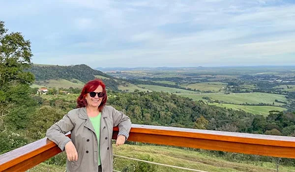 Deusa Rodrigues observando O que fazer em Pardinho ,no Cuesta Café com vista para a região.
