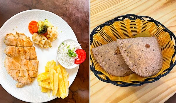 Fotografia dividida em duas partes: à esquerda, um prato branco com filé de frango grelhado, acompanhado de batatas fritas, arroz branco, brócolis, couve-flor e cenoura. À direita, uma cesta preta e amarela contendo pães achatados integrais, semelhantes a pão sírio.