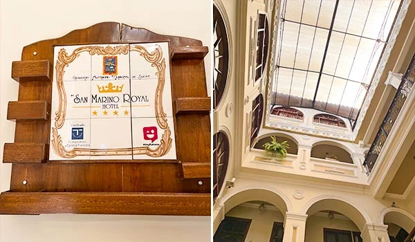 Placa de madeira com azulejo decorativo identificando o Hotel San Marino Royal, com classificação de quatro estrelas. Ao lado, vista interna do hotel, destacando um amplo átrio com arquitetura clássica, arcos, colunas e teto de vidro.